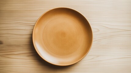 Wall Mural - Top view of empty brown ceramic plate on the light wood table.