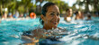 Joyful woman swimming in outdoor pool