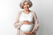 pregnant old woman holds belly on white background