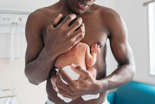 Newborn Baby Being Held By Dad After Birth
