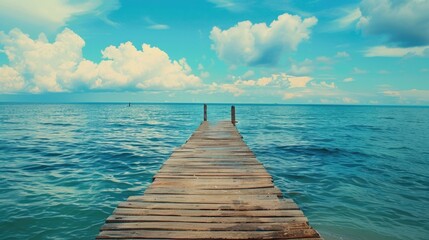 Poster - A scenic view of a wooden pier reaching out into the vast ocean. Perfect for travel and vacation concepts