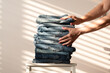 © Pixel Stories/Stocksy - Neatly folded denim jeans on chair