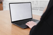 © makanna - Young white woman working on computer with blank copy space screen on table in home office. close up female businesswoman hands typing text, surfing internet on modern laptop. mock up, front view