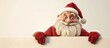 © AkuAku - Santa Claus figurine is shown holding a sign in a festive holiday setting