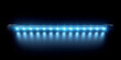 Blue shade of fluorescent lamp contrasts with black background. Fluorescent light casts luminous glow filling space with brightness.