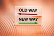 New way vs old way. Concept, New opportunities, direction of development, Written on wooden blocks, Fiery background