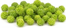   Two Piles Of Green Fruit On Separate White Tables
