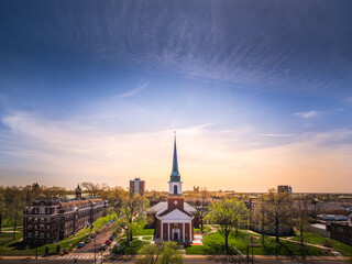 Beautiful view of Midwestern town at sunset in spring; sunset sky in  background