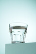 Glass of water on blue background.