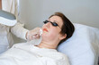 Focused laser treatment on lips, patient looks forward to results. Speaks to the desire for natural beauty restoration.