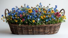 Brown Rattan Basket With Sturdy Handles, Overflowing With Wildflowers In Shades Of Blue, Yellow, And Red