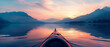 A double exposure blending a kayak with a paddle on a calm lake with a vibrant sunset in the background Faint outlines of mountains are visible on the horizon