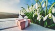snowdrops flowers and gift box on table abstract light background white snowdrops symbol of spring season romantic gentle nature image hello spring 8 march mother s day concept copy space