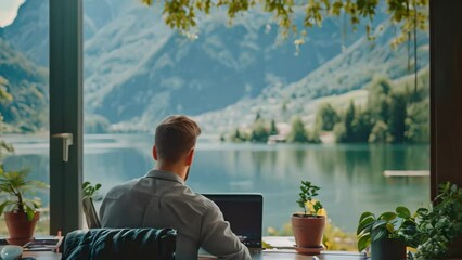 Poster - a man is sitting at a wooden desk placed in front of a large window, engaged in work or study, an it