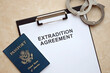Passport of United States and Extradition Agreement with handcuffs on table close up