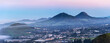 Panorama of valley, city, town, hills, mountains at sunset, sunrise
