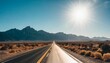 desolate desert road with mountains with sunflare western united stated