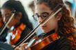 Young girl with glasses playing the violin