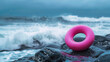 Pink rubber ring by the sea