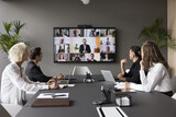 Fototapeta Panele - Group meeting using video call app. Multiethnic businesspeople profiles on screen, engaged in teleconference event by business, international communication of HR managers and applicants, career, tech