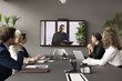 Arabic businessman speaker hold video conference for staff using application. Group of interested business people, employees listening speech, information, opinion of male boss shown on monitor screen