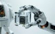 A close-up of an industrial robotic arm holding a cube glass box containing a microchip, with a white theme,
