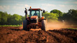 A tractor plowing a field of rich brown soil in preparation for planting, copy space