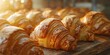 Freshly baked croissants, buttery layers visible, warm light, close focus, rich detail 