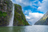 Fototapeta Góry - Photograph of Water Falls after very heavy rain and cold weather in Milford Sound in Fiordland National Park on the South Island of New Zealand