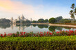 Victoria Memorial Kolkata colonial architecture building with adjoining flower garden, and lake at sunrise.