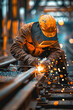 © NILSEN Studio - Sparks fly as a dedicated worker welds on a railway track, showcasing manual skill.