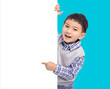 Happy Asian boy  holding and pointing white  empty banner