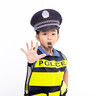 child dressed as a police officer standing and showing stop sign