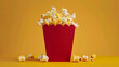 Packing popcorn in a red paper bag for watching a movie on a yellow isolated background
