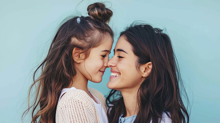 happy mother and daughter on pastel blue background