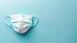 Top view medical mask on pastel blue background