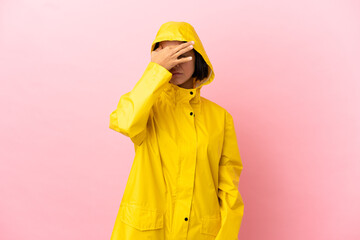 Wall Mural - Young latin woman wearing a rainproof coat over isolated background with headache