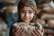 A young girl offers a burlap sack filled with peanuts with an innocent smile in a market setting