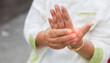 close up senior woman massage on fingers to relief pain from hard working for treatment about gout and rheumatoid symptoms and chronic illness health care concept