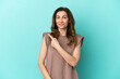 © luismolinero - Middle aged caucasian woman isolated on blue background surprised and pointing side