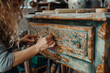 a woman that is making something out of wood with an old style dresser