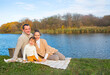 © Dasha Petrenko - Young family resting on the lake shore