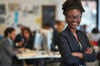 © ALL YOU NEED studio - Happy african american businesswoman standing in office with arms crossed and smiling at the camera