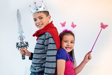 Wall Mural - Dress up, playing and portrait of children in costume for sibling bonding, relax and fun together. Family, happy and girl and boy for childhood, youth and playful on holiday, weekend and vacation