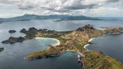 Wall Mural - Aerial time lapse of clouds passing over Padar island with beautiful pink beaches and bays in Komodo national park, Indonesia