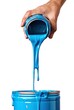 hand hold can with blue paint and pouring on white background isolated, liquid dye falling