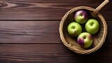 Fototapeta Dmuchawce -  Fresh apples in a woven basket on a wooden surface