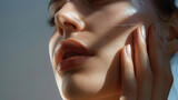 Fototapeta  - Close-up of woman's face, chin, beautiful lips and neck with touch on cheek face with one hand and natural make-up advertising with soft light and shadow created with Generative AI Technology
