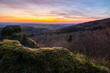 Panorama of a Romanesque landscape at sunset in the evening light. beautiful spring landscape in the mountains. Grass field and rolling hills. View from a rock to the horizon