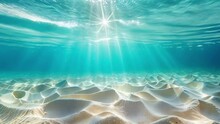 Underwater View Of The Ocean Floor With Sunlight Filtering Through The Water, Creating Patterns On The Sand And Ripples In The Crystal Clear Water. High Quality 4k Footage